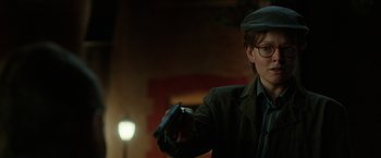 Movie still from “Predestination” (2014), directed by Michael Spierig – A man holding a remote control in his hand; Close Up shot, Over the shoulder angle