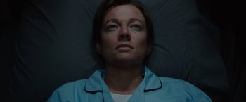 Movie still from “Predestination” (2014), directed by Michael Spierig – A woman laying in a bed looking up at the sky; Close Up shot, Overhead angle
