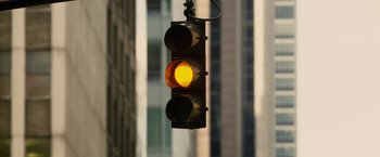 Movie still from “Premium Rush” (2012), directed by David Koepp – A traffic light hanging from a pole in front of a building; Extreme Close Up shot, Low angle