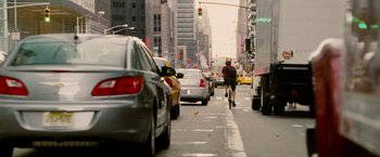 Movie still from “Premium Rush” (2012), directed by David Koepp – A man riding a bike down the middle of a busy street; Wide shot, Over the shoulder angle