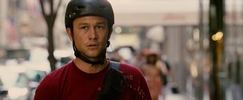Movie still from “Premium Rush” (2012), directed by David Koepp – A person wearing a helmet; Close Up shot, Over the shoulder angle