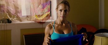Movie still from “Premium Rush” (2012), directed by David Koepp – A woman in a blue shirt is posing for a picture; Close Up shot, Over the shoulder angle