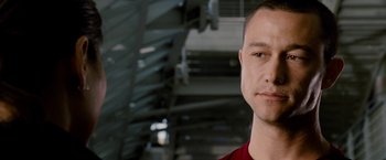 Movie still from “Premium Rush” (2012), directed by David Koepp – A person wearing a red shirt; Close Up shot, Over the shoulder angle