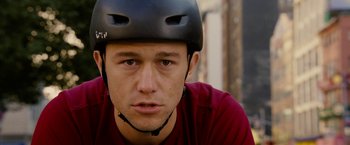 Movie still from “Premium Rush” (2012), directed by David Koepp – A person wearing a helmet; Close Up shot, Over the shoulder angle