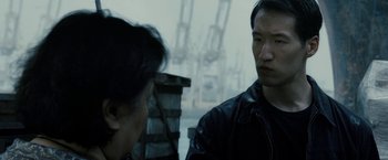 Movie still from “Premium Rush” (2012), directed by David Koepp – A man in a leather jacket talking to another man in a leather jacket; Close Up shot, Over the shoulder angle