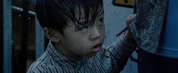 Movie still from “Premium Rush” (2012), directed by David Koepp – A young boy is looking up at the sky; Close Up shot, High angle
