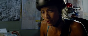 Movie still from “Premium Rush” (2012), directed by David Koepp – A woman wearing a helmet and looking at the camera; Close Up shot, Low angle
