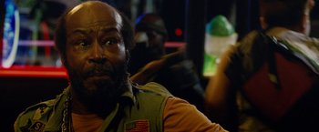 Movie still from “Premium Rush” (2012), directed by David Koepp – A man with an american flag patch on his vest; Close Up shot, Low angle