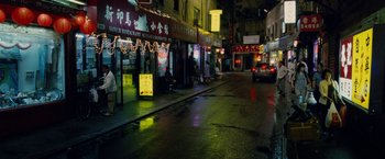 Movie still from “Premium Rush” (2012), directed by David Koepp – A city street at night lit up by street lights; Extreme Wide shot, High angle