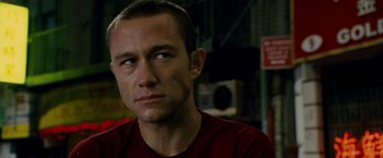 Movie still from “Premium Rush” (2012), directed by David Koepp – A person wearing a red t - shirt; Close Up shot, Over the shoulder angle