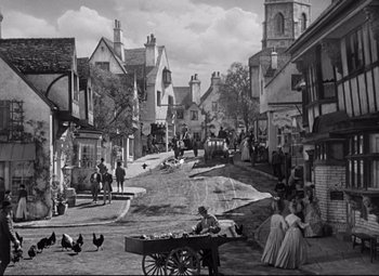 Movie still from “Pride and Prejudice” (1940), directed by Robert Z. Leonard – A black and white photo of a street scene; Extreme Wide shot, High angle