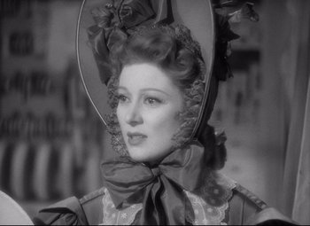 Movie still from “Pride and Prejudice” (1940), directed by Robert Z. Leonard – An old photo of a woman wearing a hat; Close Up shot, Over the shoulder angle