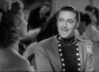 Movie still from “Pride and Prejudice” (1940), directed by Robert Z. Leonard – A black and white photo of a man in a military uniform; Close Up shot, Over the shoulder angle