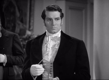 Movie still from “Pride and Prejudice” (1940), directed by Robert Z. Leonard – A man in a black suit and a white shirt; Medium shot, Over the shoulder angle