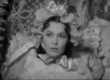 Movie still from “Pride and Prejudice” (1940), directed by Robert Z. Leonard – A black and white photo of a woman wearing a hat; Close Up shot, High angle