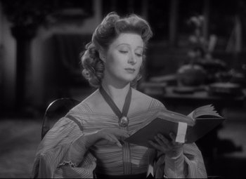 Movie still from “Pride and Prejudice” (1940), directed by Robert Z. Leonard – An old photo of a woman reading a book; Close Up shot, Low angle