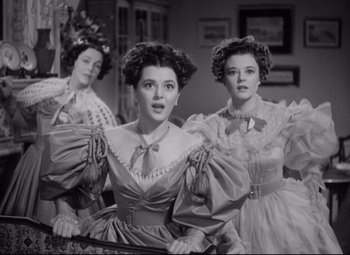 Movie still from “Pride and Prejudice” (1940), directed by Robert Z. Leonard – A group of women standing next to each other in a room; Medium shot, Low angle