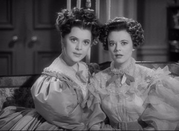 Movie still from “Pride and Prejudice” (1940), directed by Robert Z. Leonard – A couple of women are sitting next to each other; Close Up shot, High angle