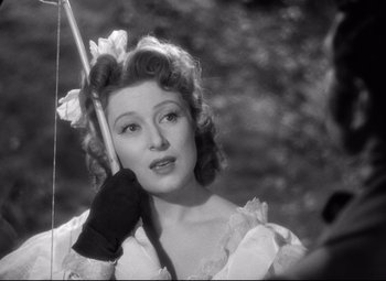 Movie still from “Pride and Prejudice” (1940), directed by Robert Z. Leonard – An old black and white photo of a woman holding a bow; Close Up shot, Over the shoulder angle