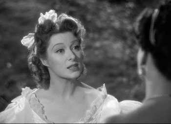 Movie still from “Pride and Prejudice” (1940), directed by Robert Z. Leonard – An old photo of a woman in a white dress looking at a man; Close Up shot, Over the shoulder angle