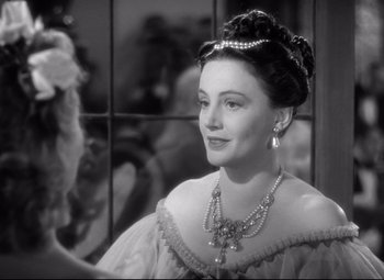 Movie still from “Pride and Prejudice” (1940), directed by Robert Z. Leonard – A black - and - white photo of a woman wearing a necklace; Close Up shot, Over the shoulder angle