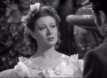 Movie still from “Pride and Prejudice” (1940), directed by Robert Z. Leonard – A black - and - white photo of a woman in a white dress; Close Up shot, Over the shoulder angle