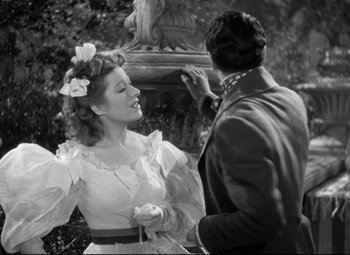 Movie still from “Pride and Prejudice” (1940), directed by Robert Z. Leonard – An old photo of a man and a woman; Medium shot, Over the shoulder angle