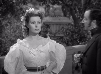 Movie still from “Pride and Prejudice” (1940), directed by Robert Z. Leonard – A black and white photo of a woman in a dress; Medium shot, Over the shoulder angle