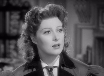 Movie still from “Pride and Prejudice” (1940), directed by Robert Z. Leonard – An old photo of a woman in a suit and tie; Close Up shot, Over the shoulder angle