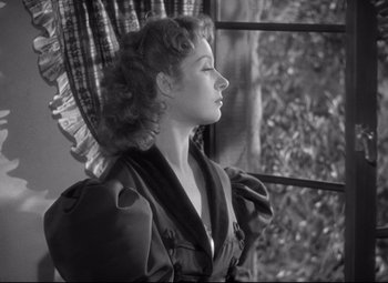 Movie still from “Pride and Prejudice” (1940), directed by Robert Z. Leonard – A black - and - white photo of a woman looking out of a window; Close Up shot, Low angle