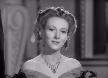 Movie still from “Pride and Prejudice” (1940), directed by Robert Z. Leonard – An old photo of a woman in a dress; Close Up shot, Low angle