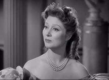 Movie still from “Pride and Prejudice” (1940), directed by Robert Z. Leonard – An old photo of a woman with a pearl necklace; Close Up shot, Over the shoulder angle