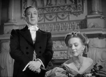 Movie still from “Pride and Prejudice” (1940), directed by Robert Z. Leonard – A man and a woman standing next to each other; Medium shot, Low angle