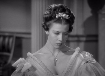 Movie still from “Pride and Prejudice” (1940), directed by Robert Z. Leonard – A black and white photo of a woman with a bow in her hair; Close Up shot, High angle