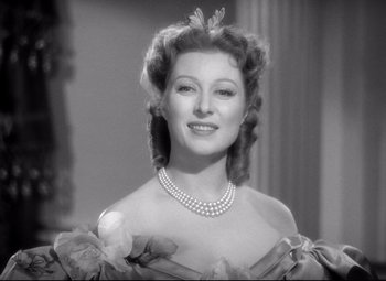 Movie still from “Pride and Prejudice” (1940), directed by Robert Z. Leonard – An old black and white photo of a woman in a dress; Close Up shot, Low angle