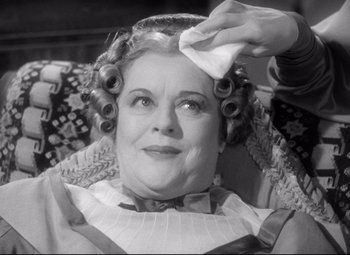 Movie still from “Pride and Prejudice” (1940), directed by Robert Z. Leonard – An older woman getting her hair combed by a stylist; Close Up shot, Low angle