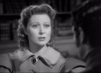 Movie still from “Pride and Prejudice” (1940), directed by Robert Z. Leonard – An old photo of a woman in a dress looking to her left; Close Up shot, Over the shoulder angle