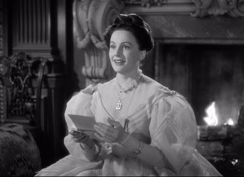 Movie still from “Pride and Prejudice” (1940), directed by Robert Z. Leonard – An old photo of a woman holding a letter; Medium shot, Over the shoulder angle