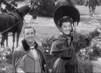 Movie still from “Pride and Prejudice” (1940), directed by Robert Z. Leonard – A man and a woman dressed in period clothing; Medium shot, Low angle