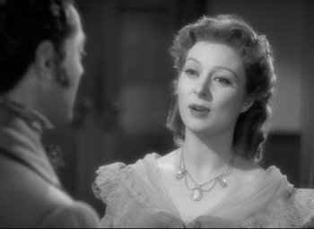 Movie still from “Pride and Prejudice” (1940), directed by Robert Z. Leonard – An old photo of a woman wearing a necklace; Close Up shot, Over the shoulder angle