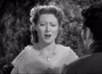 Movie still from “Pride and Prejudice” (1940), directed by Robert Z. Leonard – An old black and white photo of a woman; Close Up shot, Over the shoulder angle