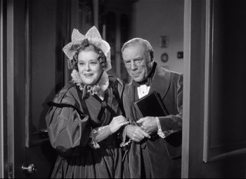 Movie still from “Pride and Prejudice” (1940), directed by Robert Z. Leonard – An older man standing next to an older woman; Medium shot, Low angle