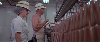 Movie still from “Prime Cut” (1972), directed by Michael Ritchie – A man working in a meat processing plant; Medium shot, Low angle