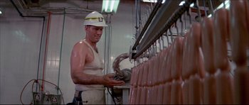 Movie still from “Prime Cut” (1972), directed by Michael Ritchie – A man working in a meat processing plant; Medium shot, Low angle