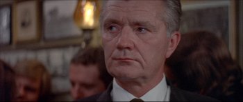 Movie still from “Prime Cut” (1972), directed by Michael Ritchie – An older man wearing a suit and tie; Close Up shot, Low angle