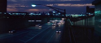 Movie still from “Prime Cut” (1972), directed by Michael Ritchie – A city street at night lit up by streetlights; Extreme Wide shot, Low angle