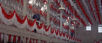 Movie still from “Prime Cut” (1972), directed by Michael Ritchie – A man standing on top of a wooden structure; Wide shot, Low angle