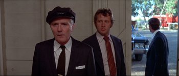 Movie still from “Prime Cut” (1972), directed by Michael Ritchie – Two men in suits and ties standing next to each other; Close Up shot, Low angle