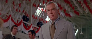 Movie still from “Prime Cut” (1972), directed by Michael Ritchie – An older man in a suit and a tie; Close Up shot, Low angle