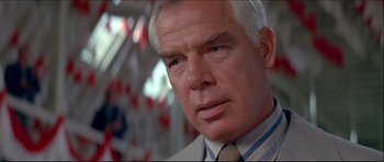 Movie still from “Prime Cut” (1972), directed by Michael Ritchie – An older man wearing a suit and a tie; Close Up shot, Low angle